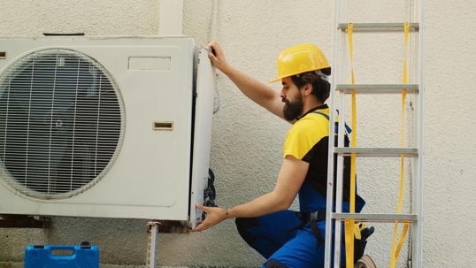 Technician checking AC unit