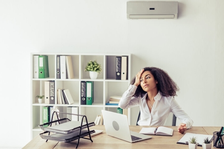 woman feeling the heat in her office
