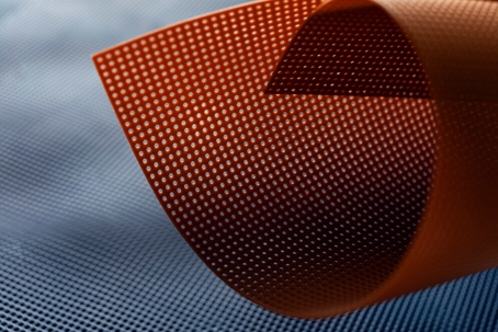 Here is an image of a flexible material with a grid of small holes that allow the material to breathe or flex.