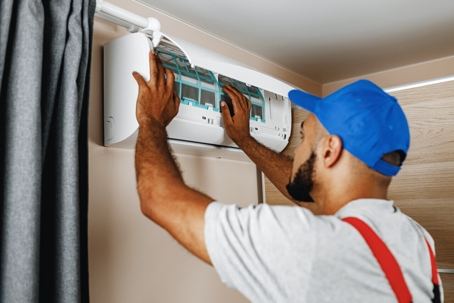 A technician fixing the AC unit