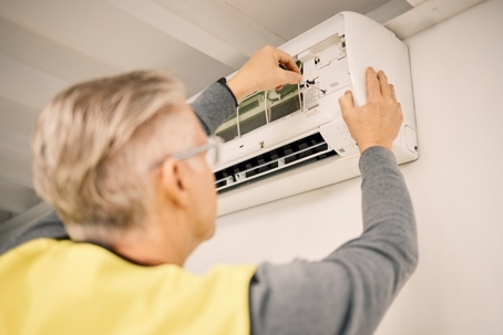 A technician installing an AC unit
