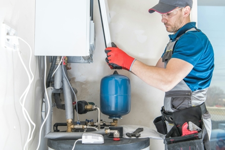 A technician repairing a furnace