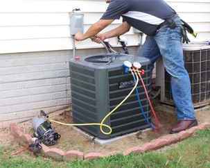 A technician is servicing an air conditioner