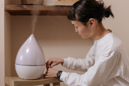 A picture of a woman and humidifier