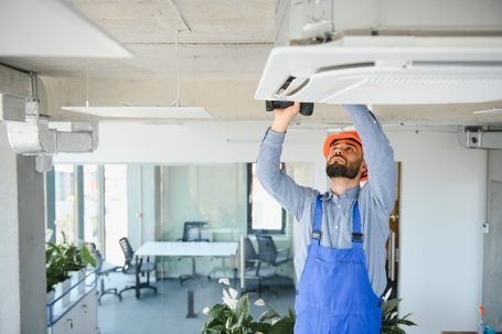 A technician tuning-up an AC unit
