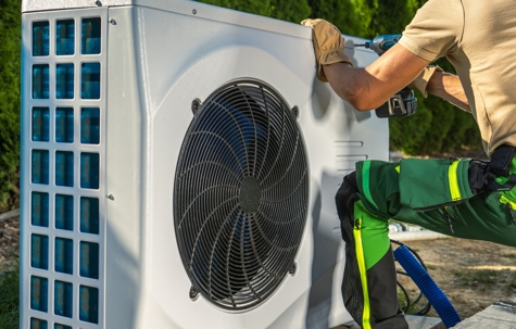 A technician repairing an AC unit